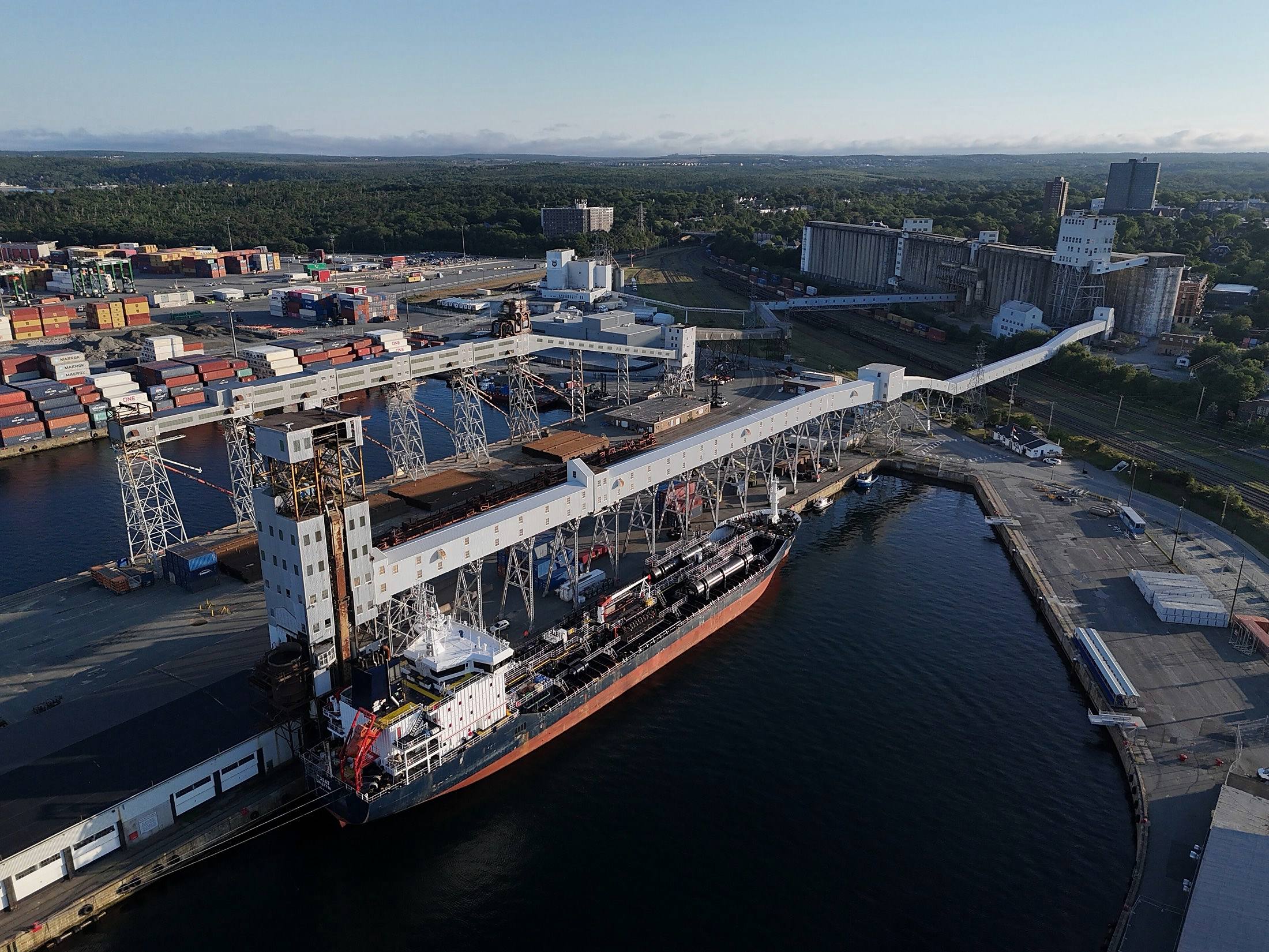 A ship alongside a grain elevator, seen across the terminal basin.