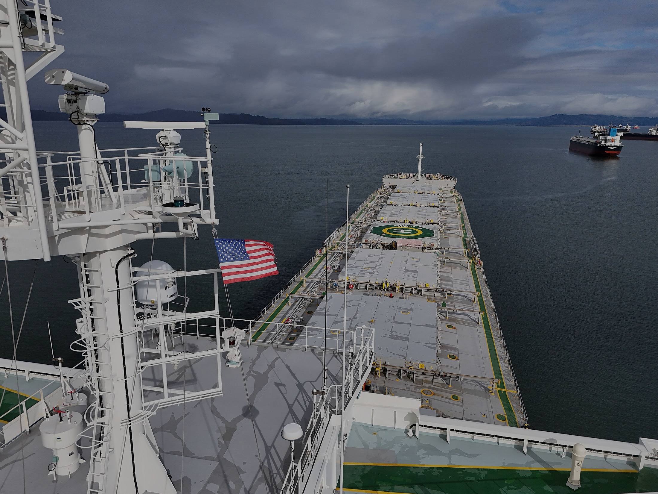 The view forward from a bulk carrier bridge, deck and sea running to the horizon.